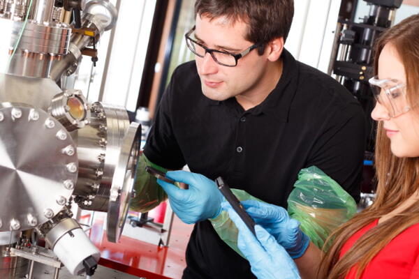 two people working on a machine