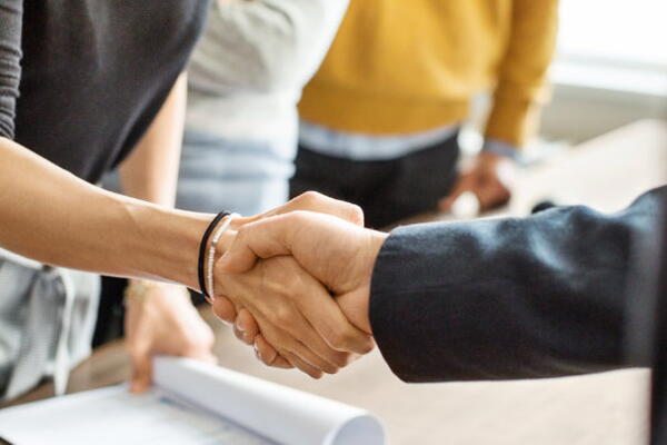 two people shaking their hands