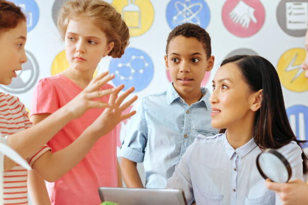 a group of students discussing something with their teacher