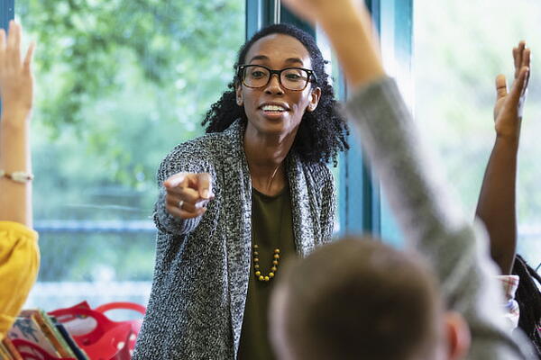 a teacher answering questions in a classroom