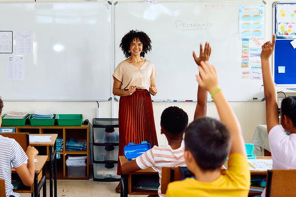 a teacher answering questions in a classroom
