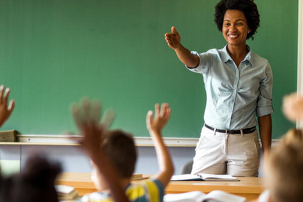 a teacher answering questions in a classroom
