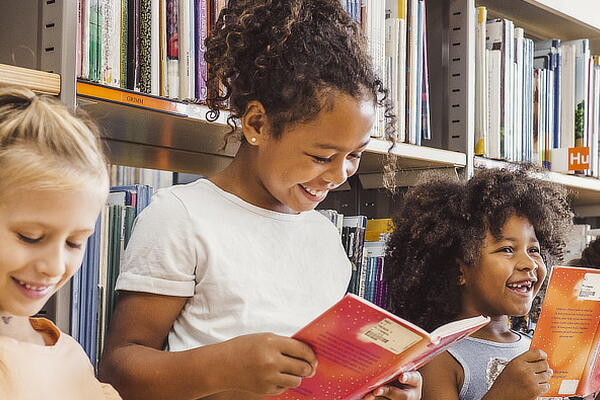 a group of students reading books in a library