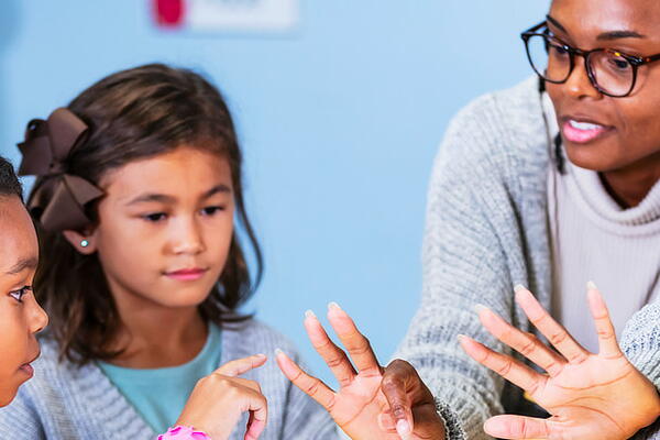 a teacher explaining something to their students
