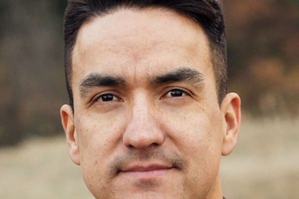 Dr. Bruno has short brown hair and is looking directly at the camera.