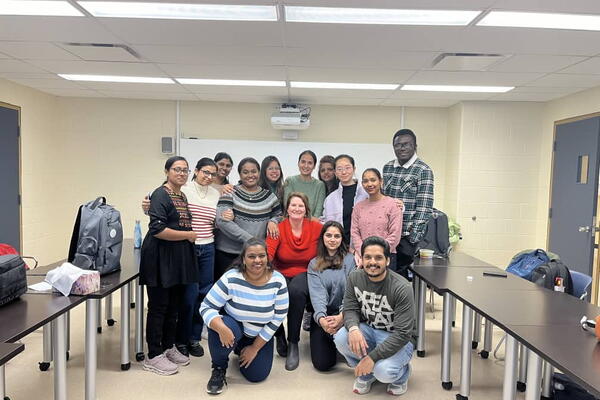 People posing in a classroom 