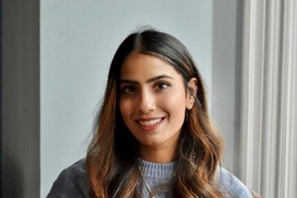 An Indian woman wearing a blue sweater