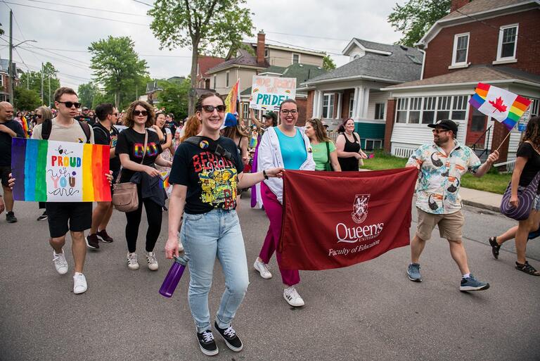 The Faculty of Education Banner Marching down the street at Pride Parade