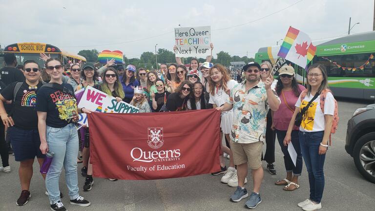Queen's Faculty of Education Banner surrounded by GSA members 