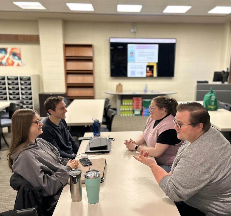 Group of students talking at a table