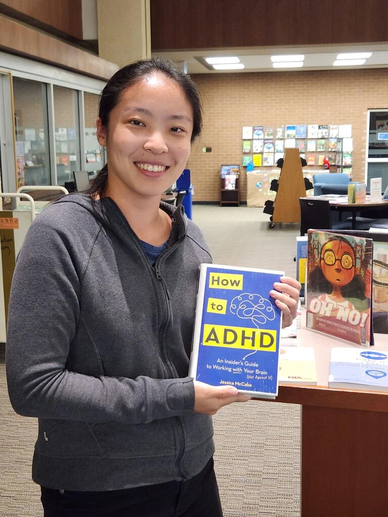 Student holding up a book