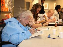 Seniors and teacher candidates doing arts activities.