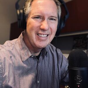 Chris Carlton smiling while recording Popular Podagogy