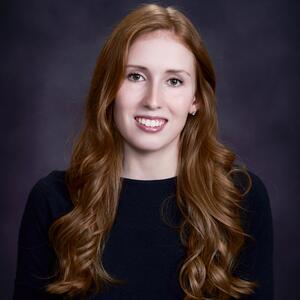 A white woman with long red hair with curls 