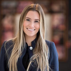 Kristy Timmons smiling in a hallway