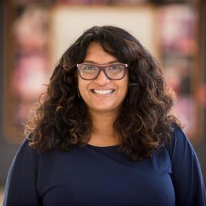 Thashika Pillay smiling in a hallway