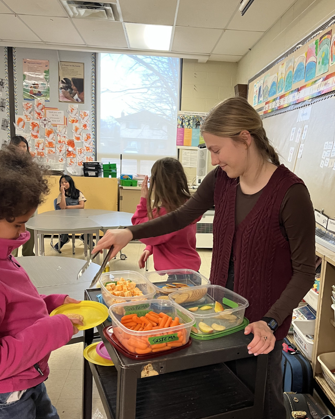 Molly helping students with snacks