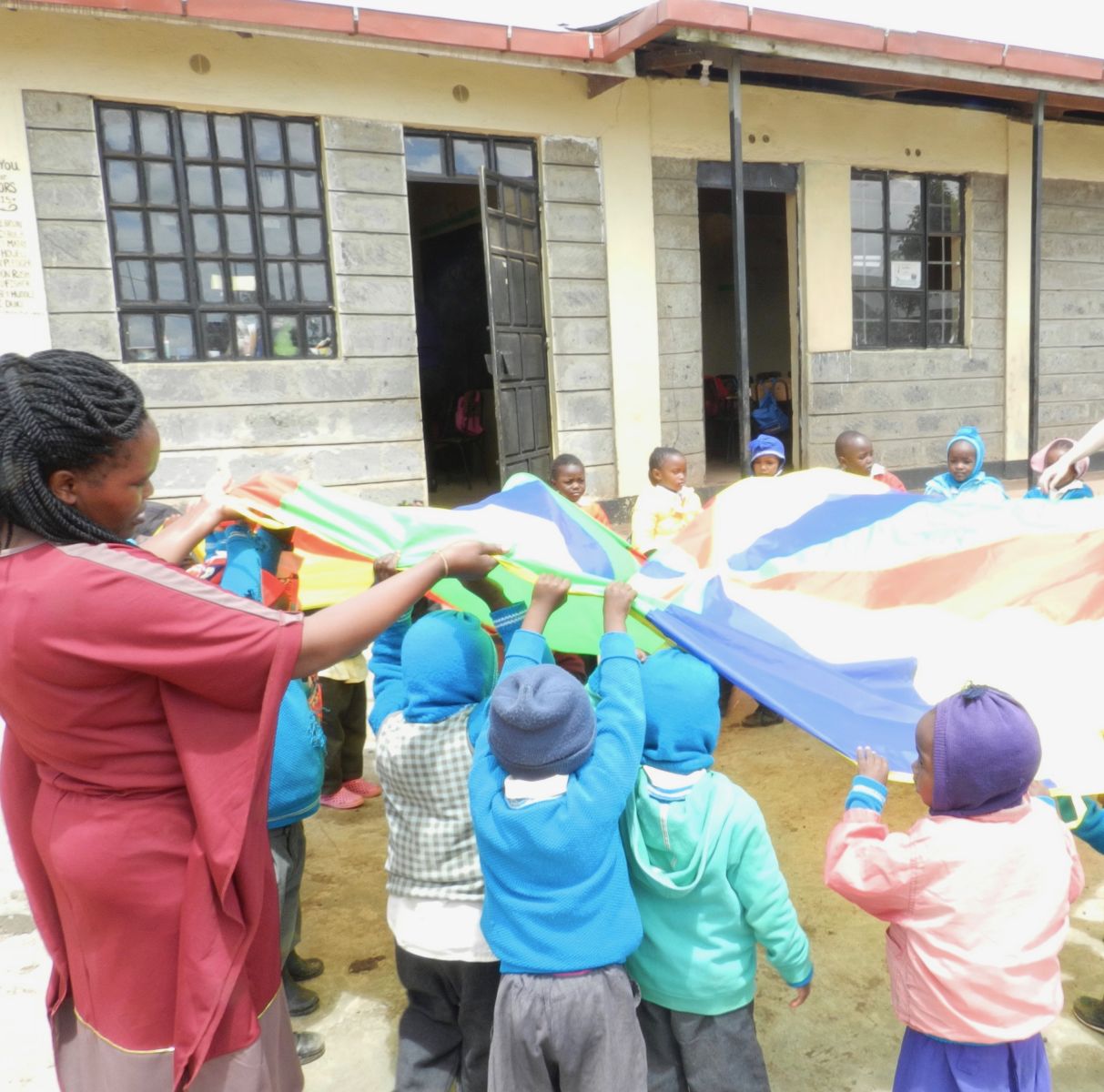 Pre School kids playing with a parachute in Kenya