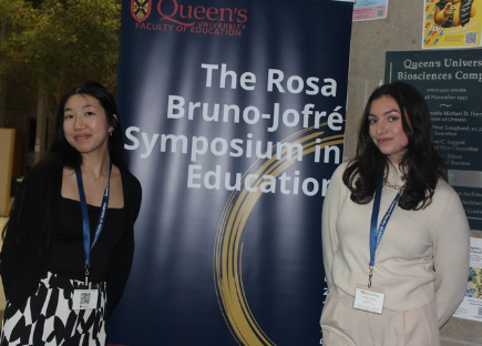 Cheryl Lee Yow and Holly Crump pose next to the RNJSE Banner