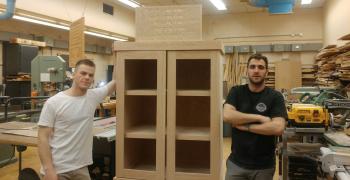 Queen's Community Cupboard with students who built it