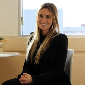 A woman with blond hair smiles 