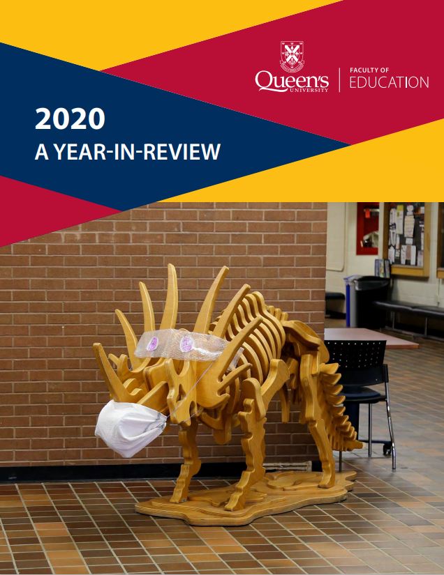 A Triceratops sculpture created out of wood with a mask on with the words "2020 a year in review" 