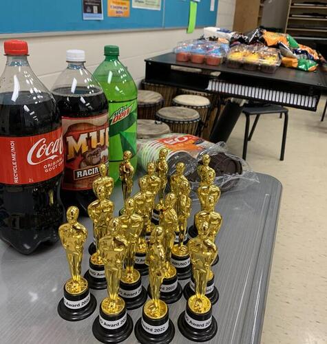 Gold statuettes sit on a classroom table