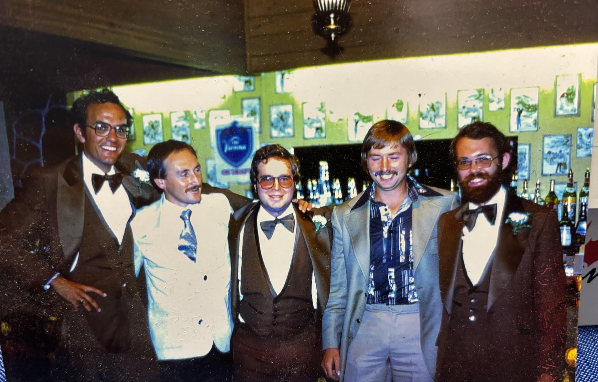 Chris Bobra and four friends smile at a wedding in a film photo from 1978.
