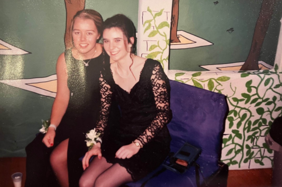 Laura Southall and a friend pose at a formal in a film photo.