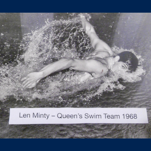 Len Minty swims in the water in a black and white photo from 1968. A caption on the photo reads "Len Minty - Queen's Swim Team 1968"
