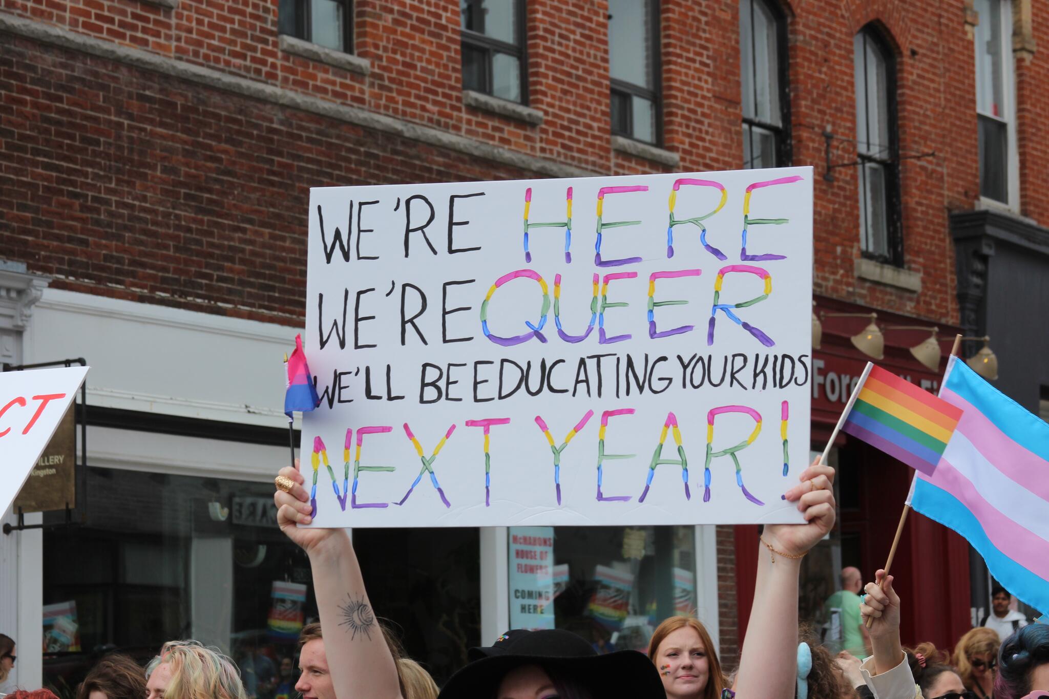 A sign that reads: We're here, we're queer, we'll be educating your kids next year