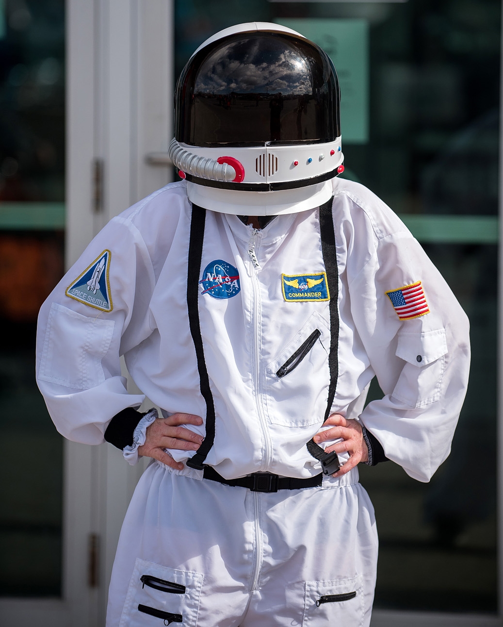 Woman in astronaut suit standing outside