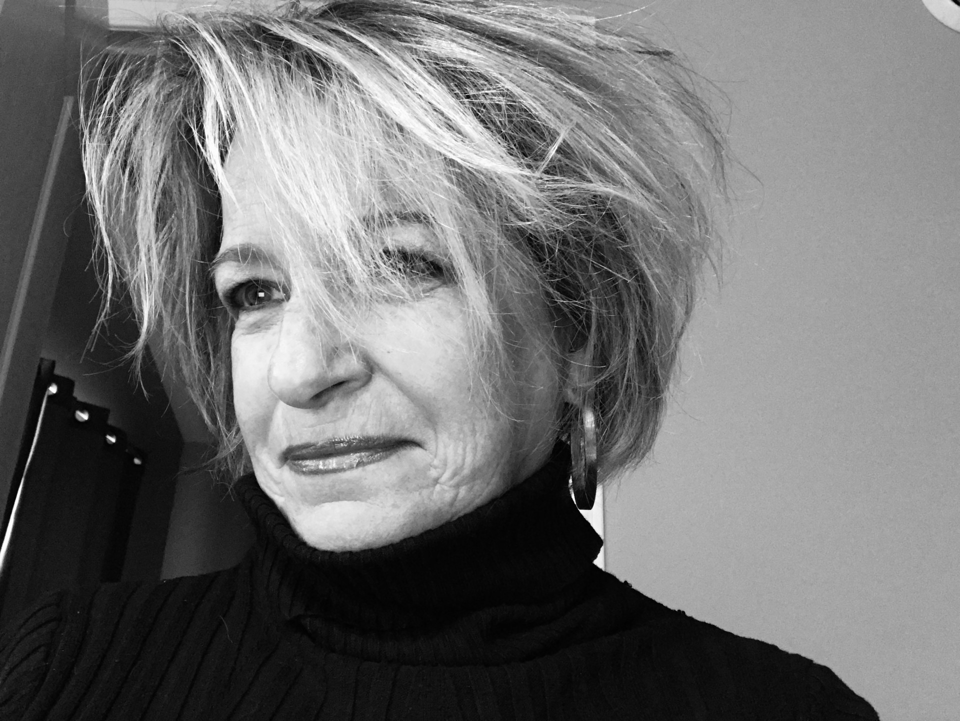 A black and white photo of Maureen Murphy smiling wearing a black turtleneck.