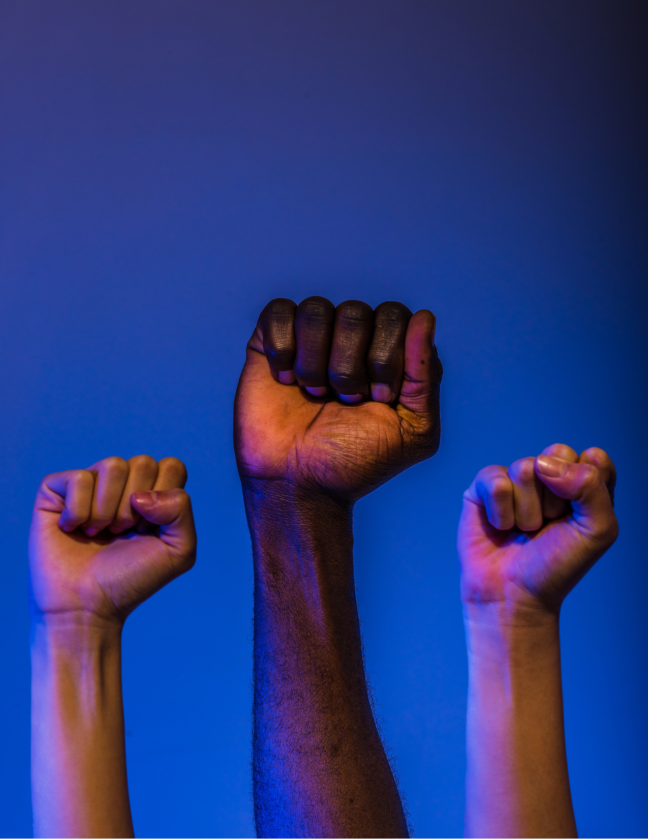 Three fists going towards the sky 
