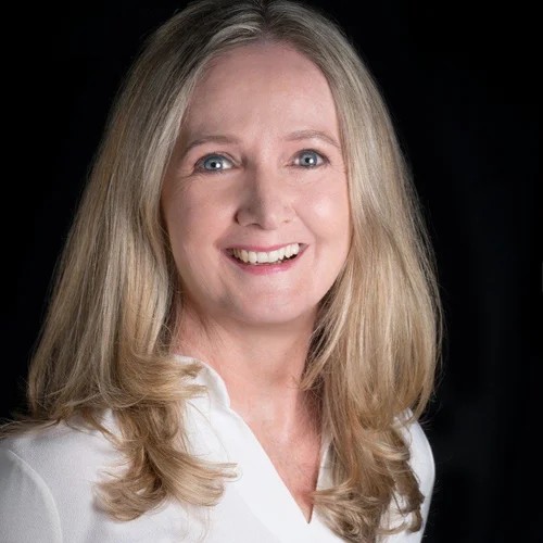 A white woman smiling at the camera 