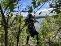 OEE Teacher Candidate bird calling on a cliff Otter Lake during Field Camp