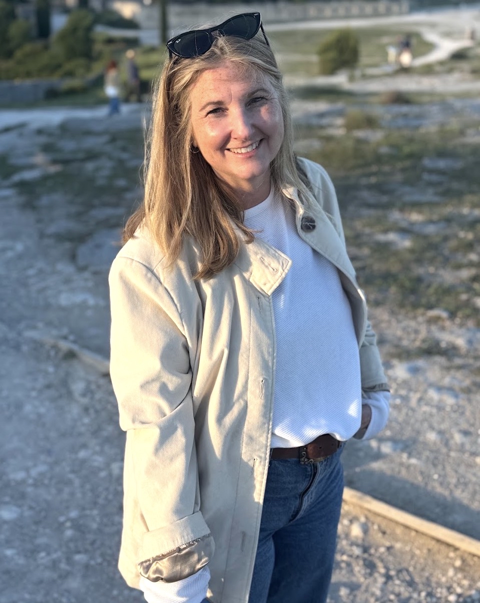 a woman poses on a beach