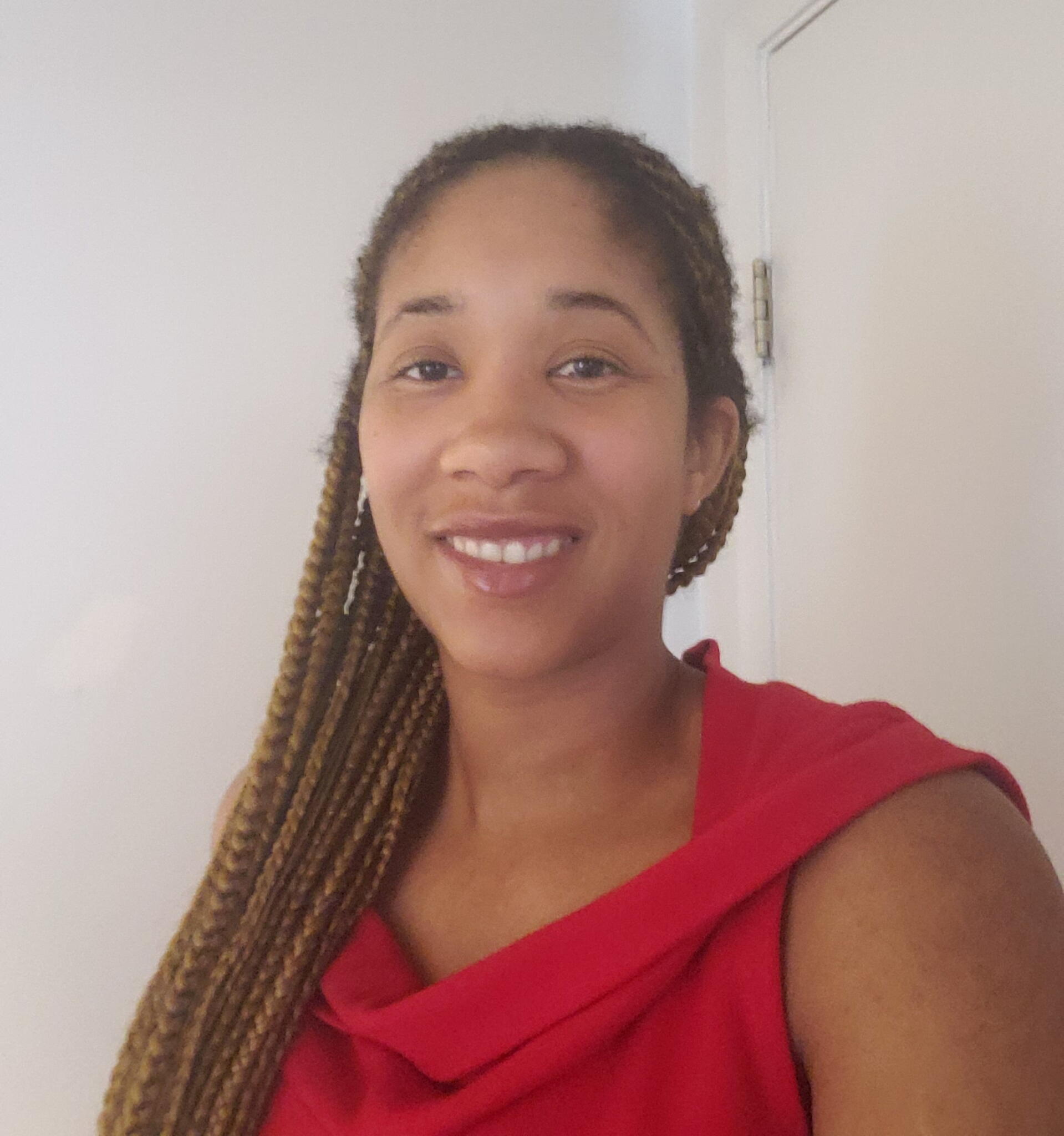 A woman with braids smiling