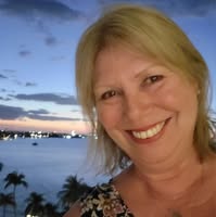 A woman who is blond in a tropical location