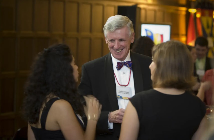 Three people at an alumni event talking 