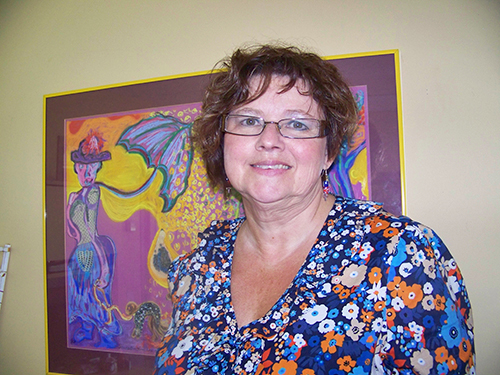 Jo-Anne Lachapelle-Beyak standing in front of a painting.