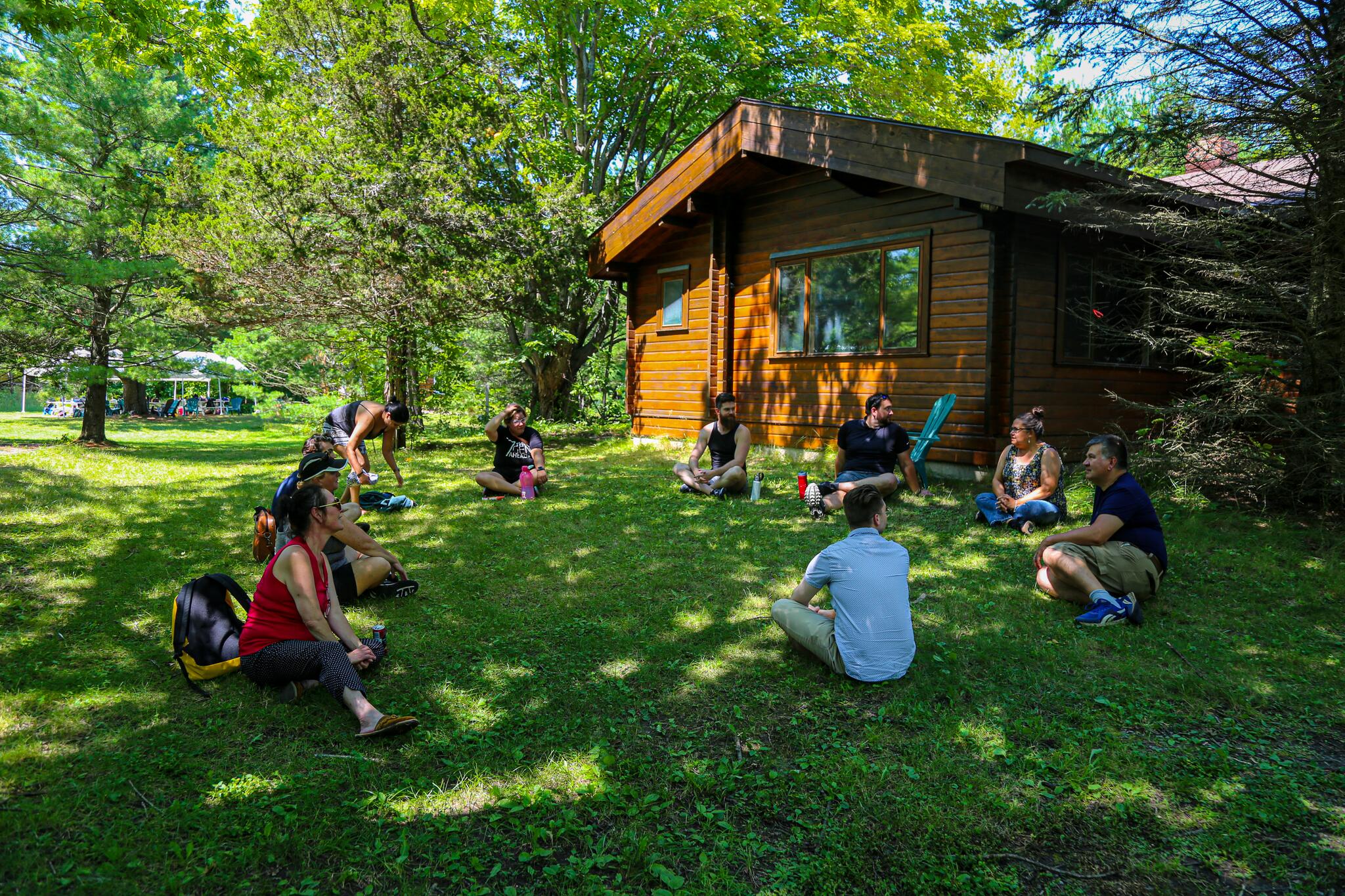 Student sitting outside of wooden structure