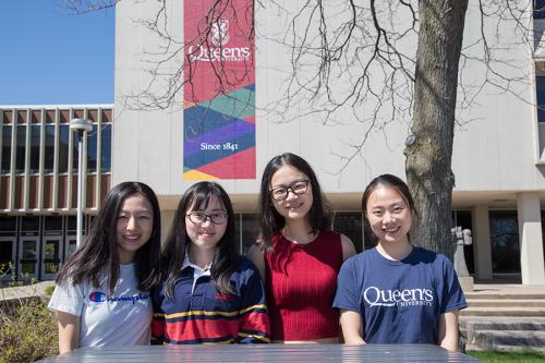 "four dual degree students standing together in front of Duncan McArthur Hall"