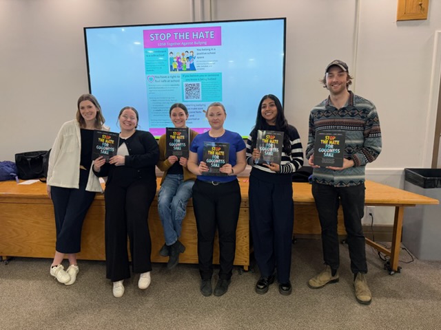 Students holding the Stop the Hate book