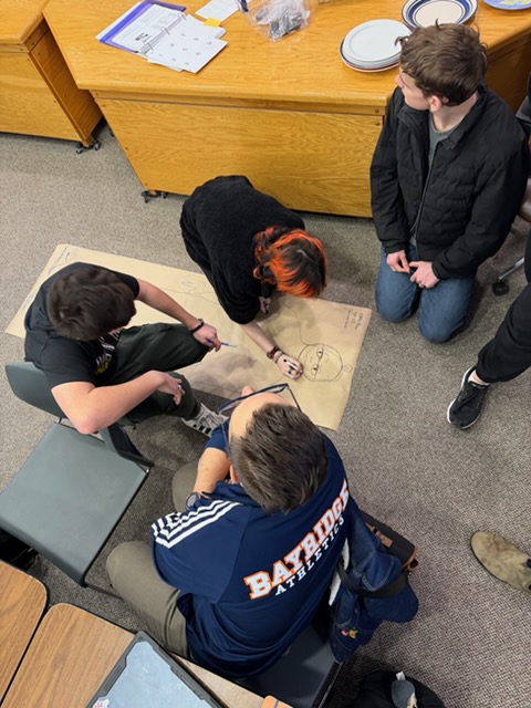 Students drawing at the seminar for the Stop the Hate book