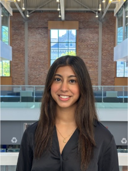 Seher Mukadam smiling at camera
AI-generated content may be incorrect.