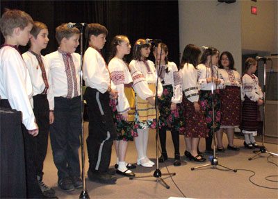 Children singing in traditional clothing.